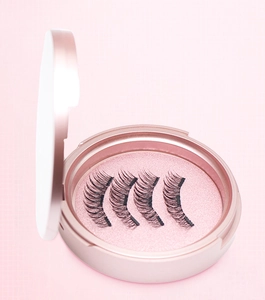 Macro view of four magnetic eyelash segments in a round pink compact storage case