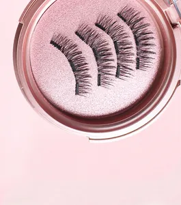 Close-up of four reusable magnetic false eyelashes in a round pink glitter storage case
