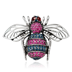 Macro view of crystal bee brooch with pink and blue rhinestones on silver metal base