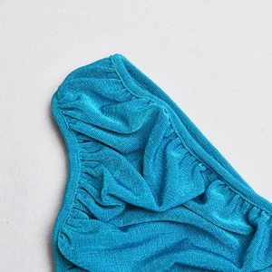 Detail view of vibrant blue fabric showing high-quality stitching and textured pleats