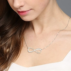 Custom silver infinity name necklace with personalized engraving on a model