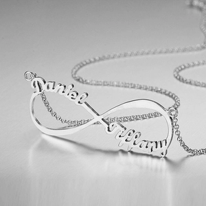 Macro detail of custom stainless steel infinity pendant engraved with Daniel and Tiffany names