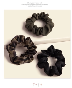 Three-piece hair scrunchie set including dark green, animal print, and black ribbed fabric