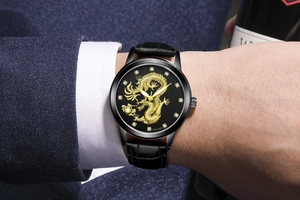 Close-up of luxury gold dragon relief watch with rhinestone markers on leather strap