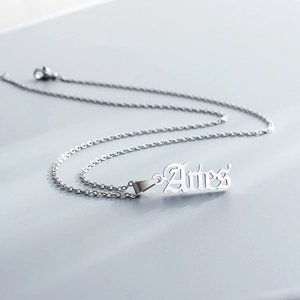 Detailed view of silver stainless steel Aries zodiac pendant on a delicate O-link chain