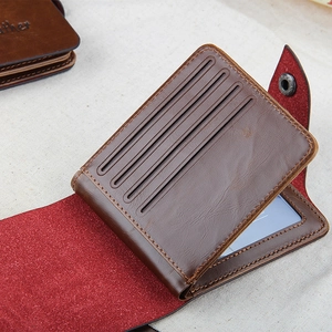 Detail view of brown leather tri-fold wallet showing card slots and transparent photo ID window