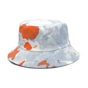 Detail of blue and white tie-dye cotton bucket hat with orange Australia map pattern