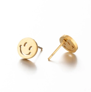Close-up of golden hollow smile face stud earrings with polished metallic finish