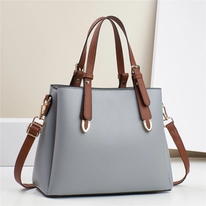 Grey textured leather Boston handbag with brown handles and adjustable crossbody strap