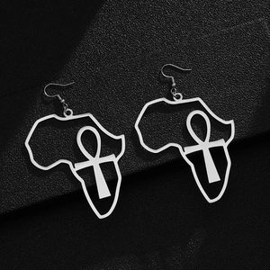 Macro shot of silver stainless steel earrings with Africa map and Ankh symbol cutouts