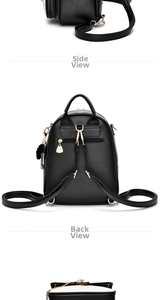 Detail view of mini black PU backpack featuring gold zippers and a plush fur ball charm