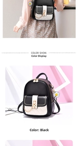 Detail of a mini black PU leather backpack with contrast front pocket and sunflower charm