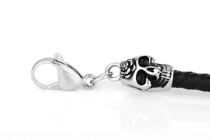Detail of the lobster clasp and vintage silver skull pendant on black braided leather