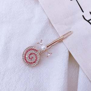 Elegant gold lollipop hair clip with red and white rhinestones and a central pearl