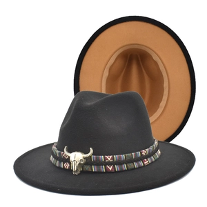 Detail of black fedora hat featuring colorful woven band and silver bull head ornament