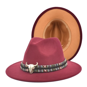 Detail of wool fedora with wine red and camel bicolor design and silver bull skull accent