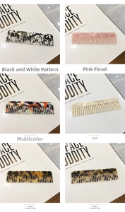 Close-up of wide-tooth acetate combs in six assorted tortoiseshell and marble patterns