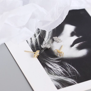 Close-up of gold and silver S925 sterling silver marquise-cut marquise stud earrings