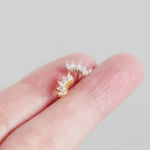 Macro detail of gold and silver S925 sterling silver earrings with marquise zirconia