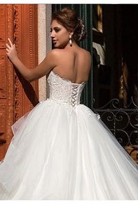 Lace bodice detail with elegant sweetheart neckline and corset lace-up back wedding gown