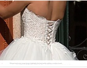 Lace-up back detail of a white wedding dress with elegant floral embroidery and tulle