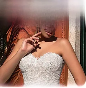 Detailed close-up of intricate floral lace bodice on an elegant white wedding dress