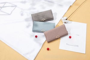 Three long PU leather wallets with leaf stitching, metal flower buckles in grey, blue, and pink