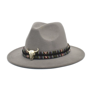 Classic grey felt fedora hat featuring an ethnic woven band and golden bull skull charm