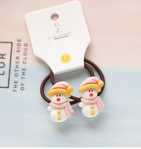 Close-up of kids Christmas hair ties with cute white snowman resin charms on brown bands