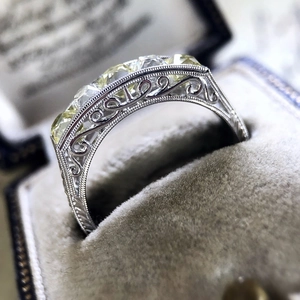 Vintage silver alloy ring with amber zircon and hollow floral design in a gray box