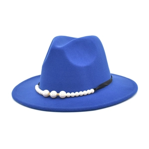 Close-up of royal blue wool fedora hat featuring black band with white pearl ornaments