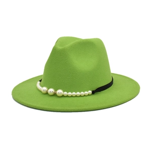 Detailed view of lime green wool jazz fedora featuring a black ribbon with pearl accents