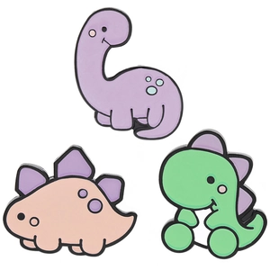 Detailed view of three cute cartoon dinosaur enamel pins in purple pink and green colors