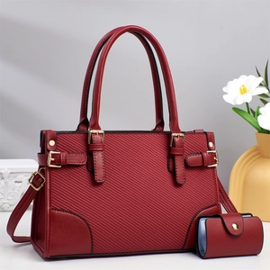 Elegant dark red leather handbag set with quilted texture and gold-tone metal hardware