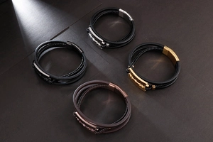 Detail of woven leather bracelets with razor blade steel pendants in four color options