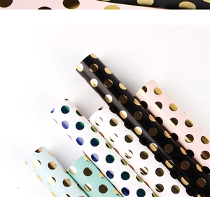 Polka dot gold foil wrapping paper rolls in black, white, pink, mint, and sky blue colors