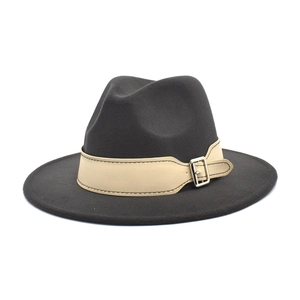 Close-up of wide-brimmed felt wool jazz hat with a beige strap and silver metal buckle