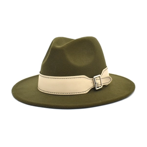 Detail of dark olive wool fedora hat featuring off-white leather band and silver buckle