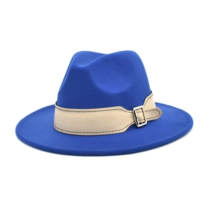 Close-up of royal blue wool fedora hat with beige decorative band and silver buckle