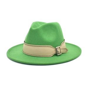 Detail of bright green wide brim fedora with cream leather band and silver buckle