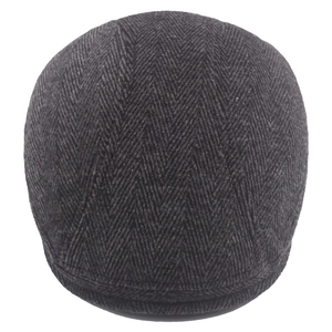 Classic dark grey herringbone flat cap made of thick wool tweed fabric in British style
