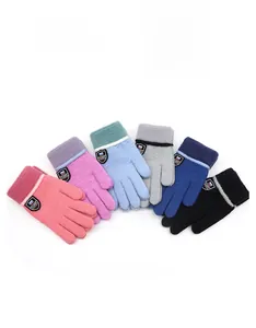 Detail view of warm knitted winter gloves for kids in six colors with shield patch