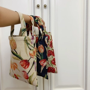 Detailed view of woven jacquard handbags featuring vintage tulip floral patterns