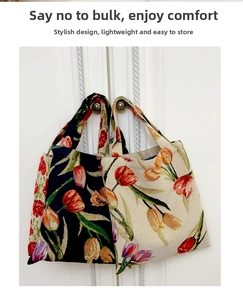 Detail of vintage tulip jacquard handbags in navy blue and cream white floral patterns