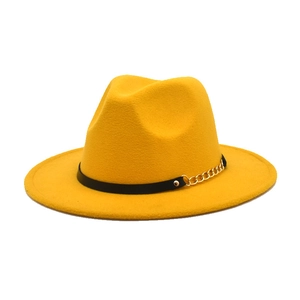 Detail of yellow fedora wool hat showing black leather belt and gold chain buckle accent