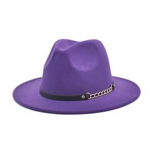 Detail of purple fedora hat featuring black faux leather band and gold chain accent