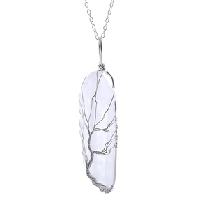 Macro shot of silver wire tree of life wrapped around a white natural crystal pillar