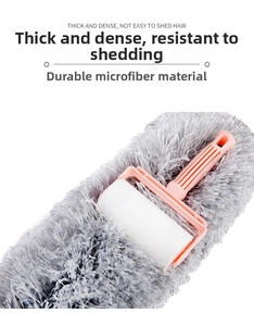 Detail of grey microfiber duster head and pink lint roller for home cleaning
