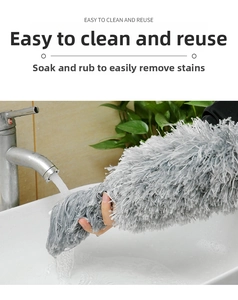 Washable microfiber dusting head being rinsed under a faucet for easy reuse and cleaning
