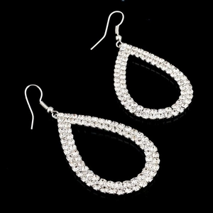 Close-up of silver water-drop earrings with clear crystals on a black background